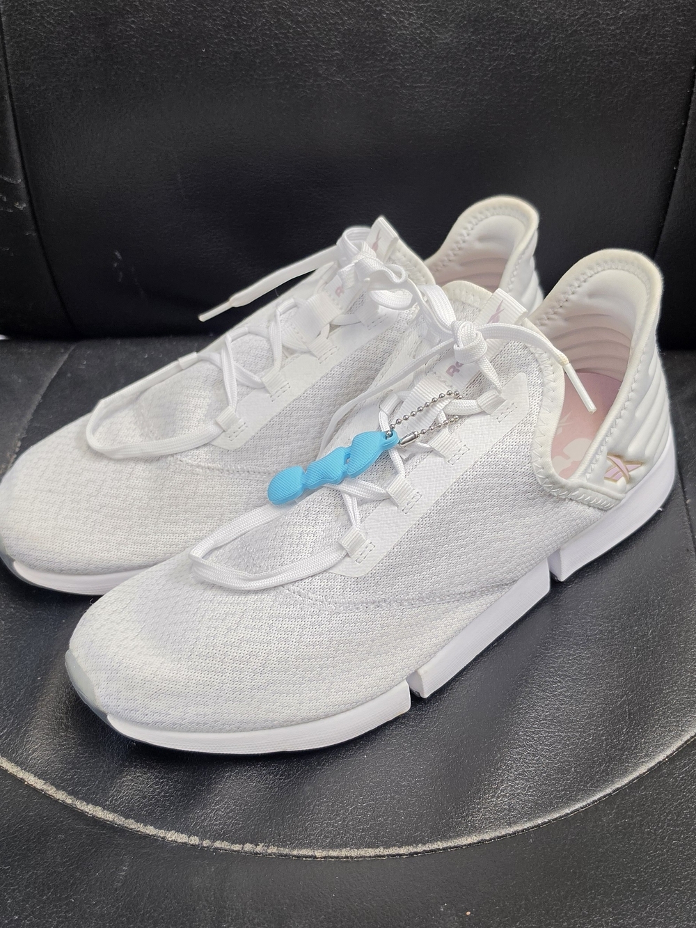 Reebok White Knit Sneakers with Blue Charm Accent